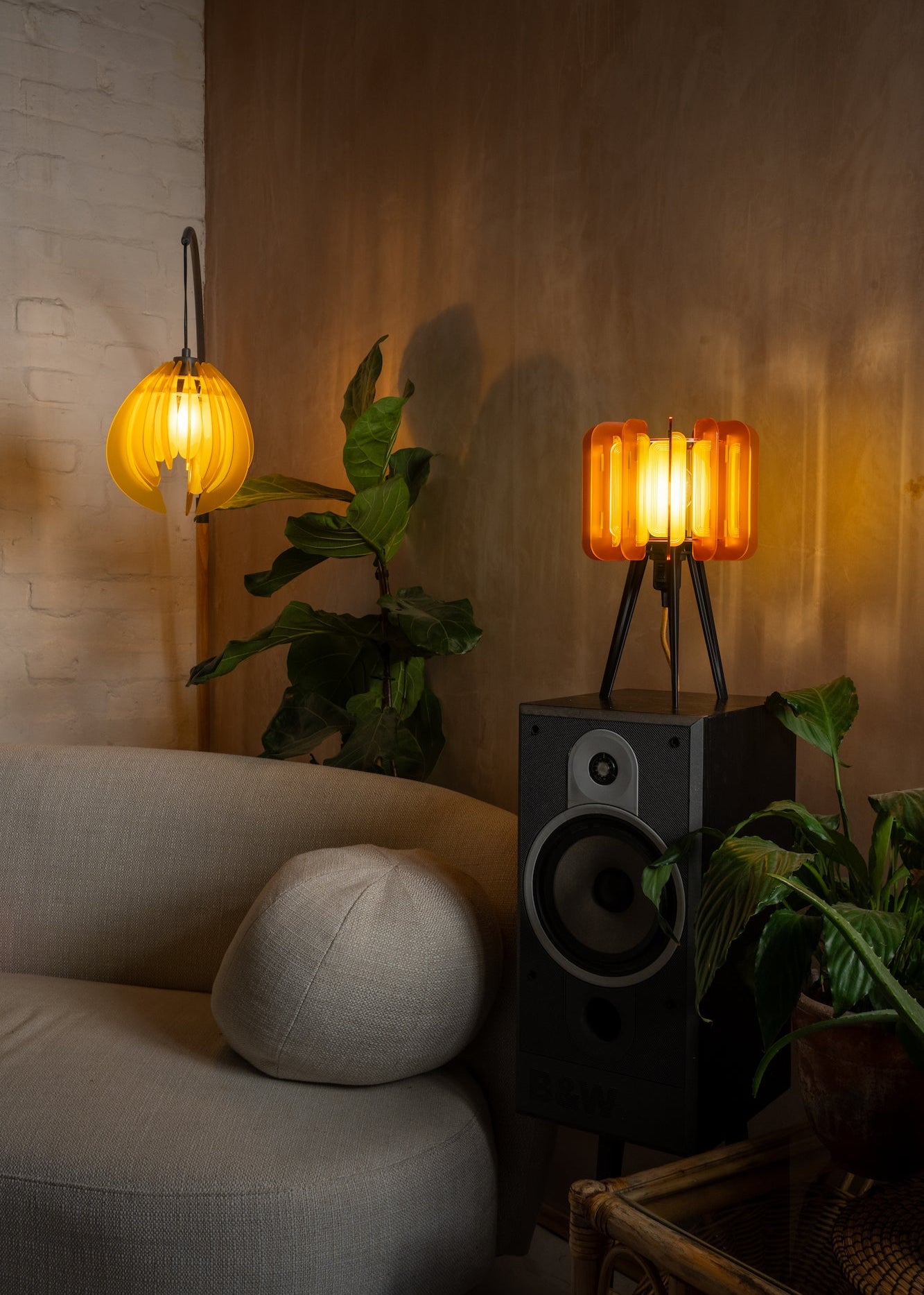 A pair of Mini Poppy lamps in Burnt Orange and Saffron, styled on a vintage teak sideboard. The warm, 70s-inspired tones and sculptural acrylic design add a nostalgic yet modern touch to any interior. Ideal for retro home styling and handmade lighting collectors.