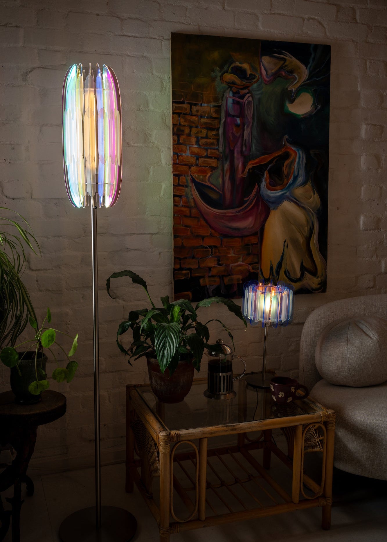 A pair of Mini Poppy lamps — one in Arctic Blue, one in Frosted Iridescent — styled on matching nightstands. The soft, ambient light and handmade sculptural design tie the bedroom together with a warm, modern glow. Perfect for cohesive small space interiors.